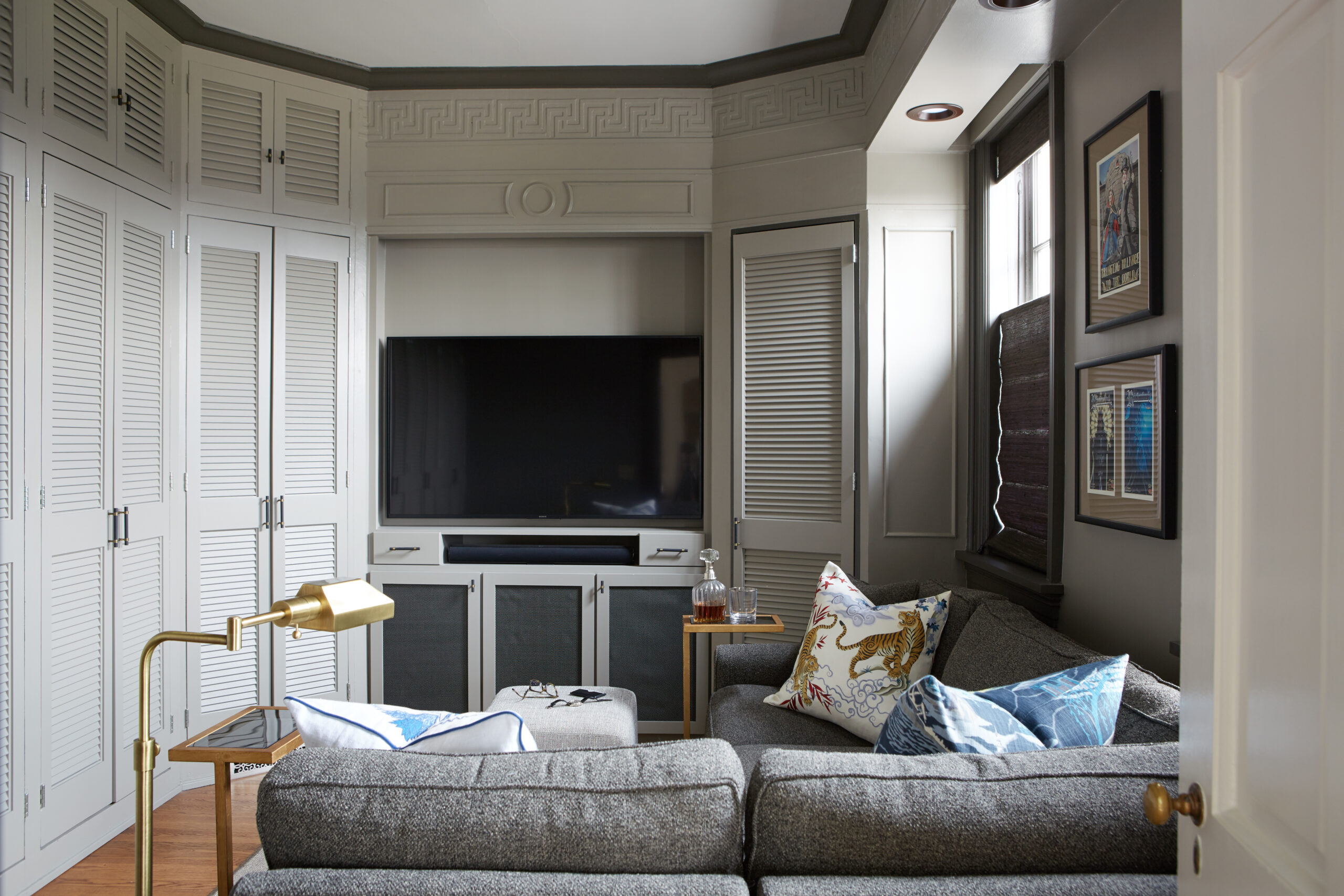 Tv room with dark color palette. relaxing space with fun accents.